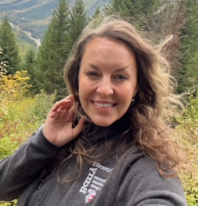 Cassie smiles for the camera during a picturesque hike