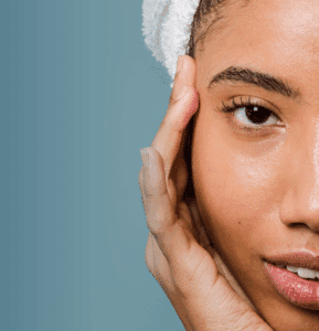 A woman with fresh, beautiful skin thanks to the latest cosmetic dermatology innovations stares into the camera